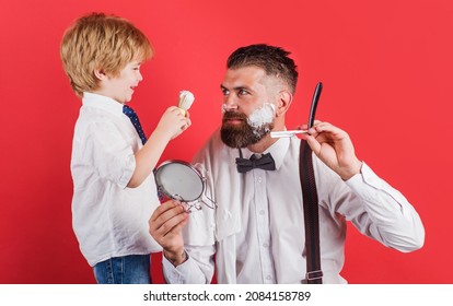 Little Barber. Salon For Men. Assistant For Dad. Barbershop Concept. Shaving Beard In Barber Shop.