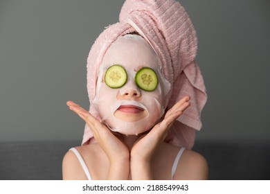 a little beautiful girl is doing spa treatments. Mask with cucumbers on the face - Powered by Shutterstock