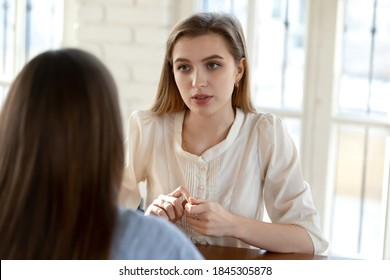 A little bit nervous. Worried stressed young woman job applicant trying to keep calm and make good impression on female hr recruiter at interview, feeling insecure, afraid to give incorrect answer