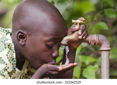 Little black boy asking begging for clean water. Its scarcity affects every continent. Around 1 billion people, live in areas of physical scarcity, and many more people approach this situation.