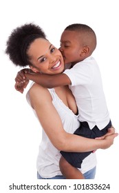 Little black boy kissing her mother, isolated on white background