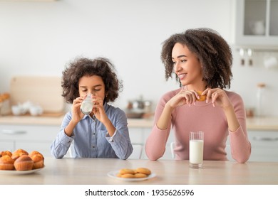 Little Black Girl And Afro Woman Drinking Milk