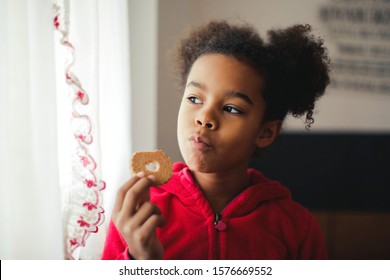 Little Black Girl Eating A Biscuit.