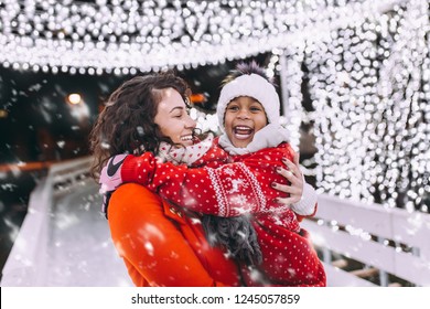 Little Black Girl Enjoying In Ice Skating With Her Mother.