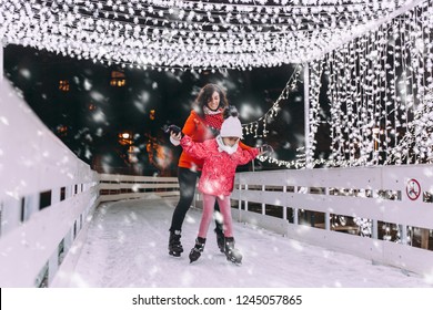 Little Black Girl Enjoying In Ice Skating With Her Mother.