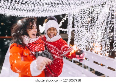 Little Black Girl Enjoying In Ice Skating With Her Mother.