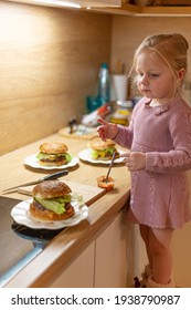 Little Blond Girl Is Cooking Home Made Burgers In Her Kitchen At Home