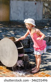 Little Blond Girl Playing With Wooden Water Mill Attraction 