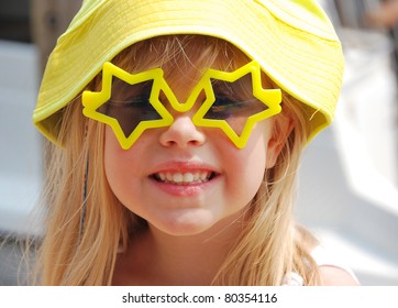 Little Blond Girl Wearing Star Sunglasses