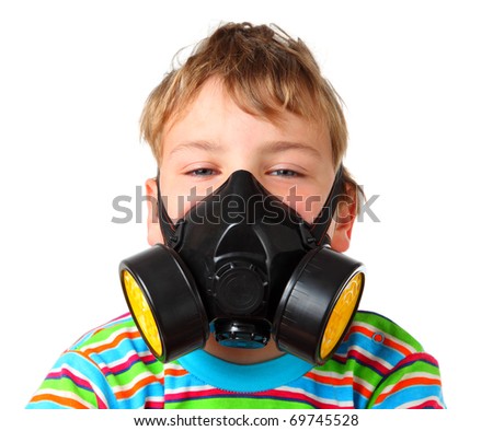 Little blonde boy screw up ones eyes in black respirator on a white background