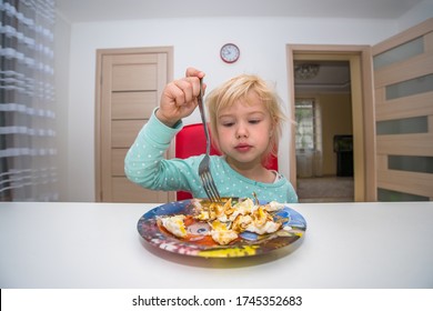 Little Blonde Girl Eating Breakfast At Home In The Kitchen Omelet No Appetite. Beautiful Baby. Homemade Food.