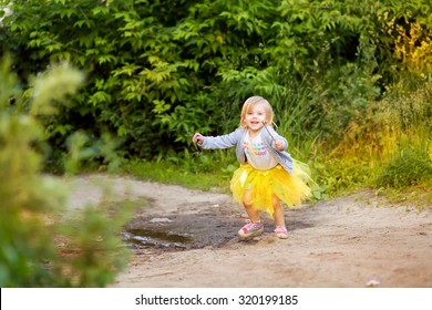 Little Blonde Girl In A Skirt Tutu Run