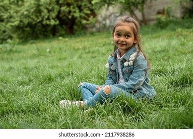 Little Blonde Girl Squatting Green Grass Stock Photo (Edit Now) 2117938286