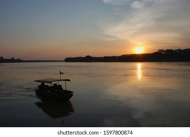 A Little Boat On A Sunset At Madre De Dios River