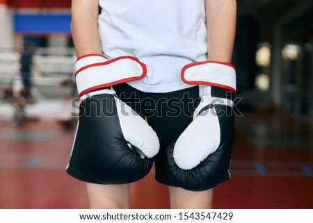 little boxer in gloves posing to the camera. close up cropped photo