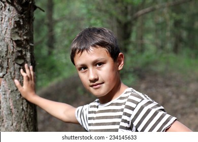 Little Boy 10 Years Old Against Forest