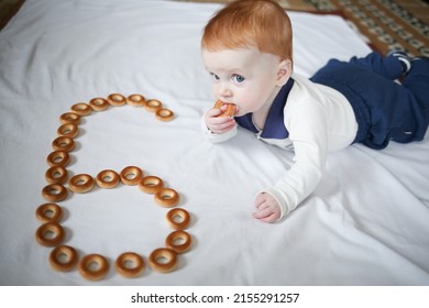 A Little Boy Of 6 Months Eats Bagels