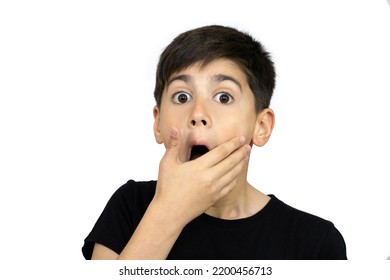 Little Boy Asian Kid Wearing Casual Black Tshirt Scared And Amazed With Open Mouth For Surprise, Disbelief Face. Isolated On The White Background