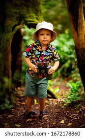 Little Boy With Binocle In The Hands And Hat ,walks In The Safari Park