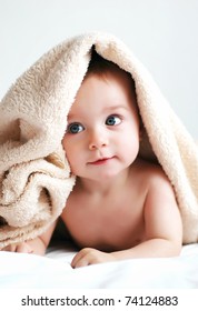 Little boy with a blanket on head
