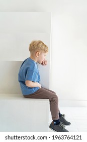 little boy with blond hair, sitting with his back turned away from everyone. The sad child, offended, turned his back. Autism, communication problems, bullying. Full-length