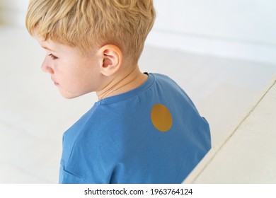 Little Boy With Blond Hair, Sitting With His Back Turned Away From Everyone. The Sad Child, Offended, Turned His Back. Autism, Communication Problems, Bullying. Close-up