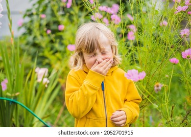 Little boy is blowing his nose on green meadow near flowers. Flower allergy concept - Powered by Shutterstock