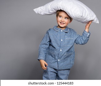 Little Boy In Blue Pyjamas With Pillow