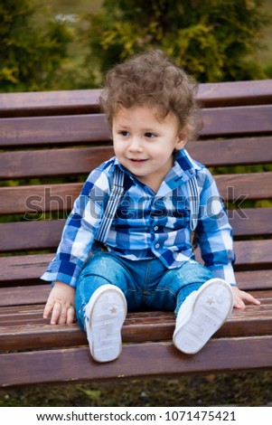 little boy in a blue shirt