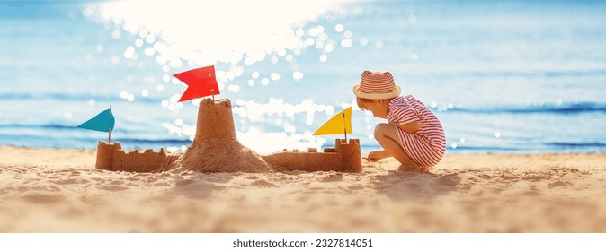 Little boy building sand castle on the sea beach. - Powered by Shutterstock