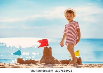 Little boy building sand castle on the sea beach. - Powered by Shutterstock