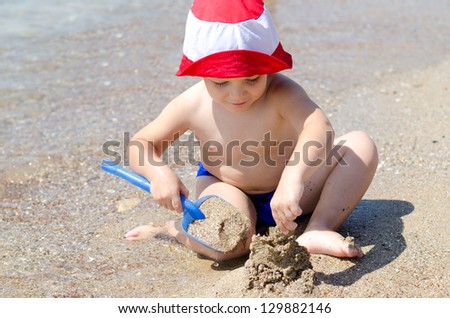 Similar – Image, Stock Photo Small child buried in the sand of the beach