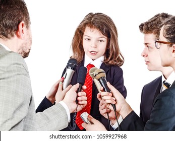 A Little Boy In A Business Suit Gives An Interview. Isolated On White