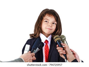 A Little Boy In A Business Suit Gives An Interview.