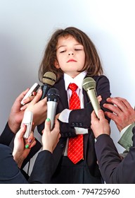 A Little Boy In A Business Suit Gives An Interview.