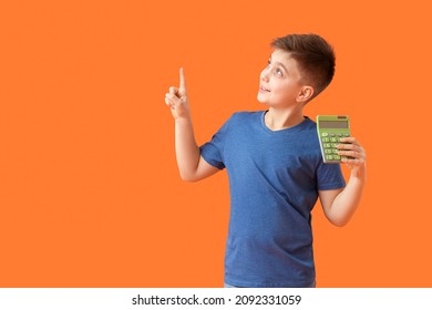 Little boy with calculator showing something on color background - Powered by Shutterstock