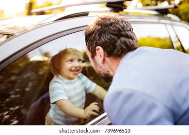 Little Boy In The Car, Looking Out Of Window At His Father.