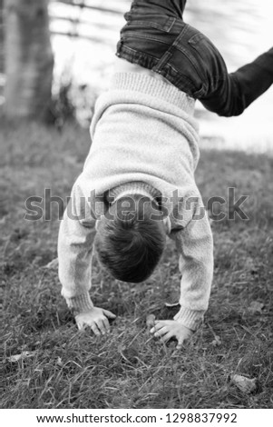 Similar – Image, Stock Photo scared boy hiding in his mom’s dress