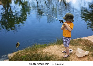 Little Boy Catching a Fish