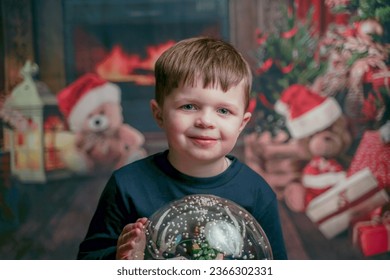 little boy with christmas snow globe on christmas background  - Powered by Shutterstock