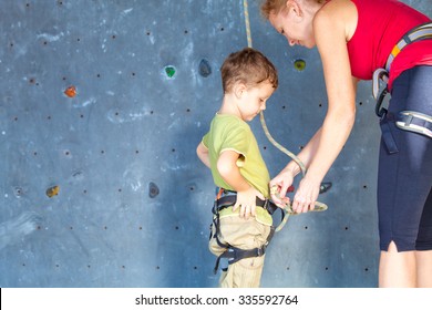 Little Boy Climbing A Rock Wall Indoor