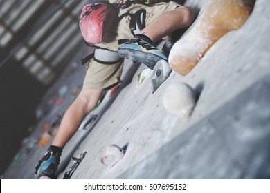 Little Boy Climbing A Rock Wall Indoor