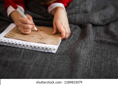 Little boy coloring and drawing at Christmas. - Shutterstock ID 1189815079