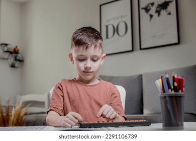 Little boy Counting with help an abacus. Mental arithmetic, brain development.