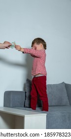 Little Boy Covered His Eyes With His Hand And Gives Money To A Stranger. Little Boy Stealing Money From Parents. 