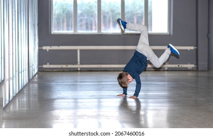 little boy dancing break dance in the hall