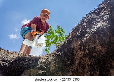 Little Boy Digging A Big Hole.