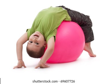 Little Boy Doing Gymnastic Exercises With A Large Rubber Ball