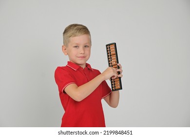 Little boy doing simple math exercises with abacus scores. Math and mental arithmeric.