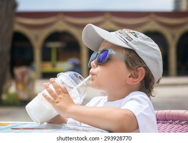 Little Boy Drinking Milkshake Through A Straw